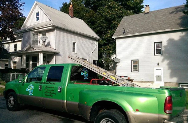 Pressure Washer Plus' truck in front of a house