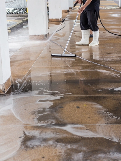 Worker cleaning sand wash exterior walkway using polishing machine and chemical or acid Worker cleaning sand wash exterior walkway using polishing machine and chemical or acid